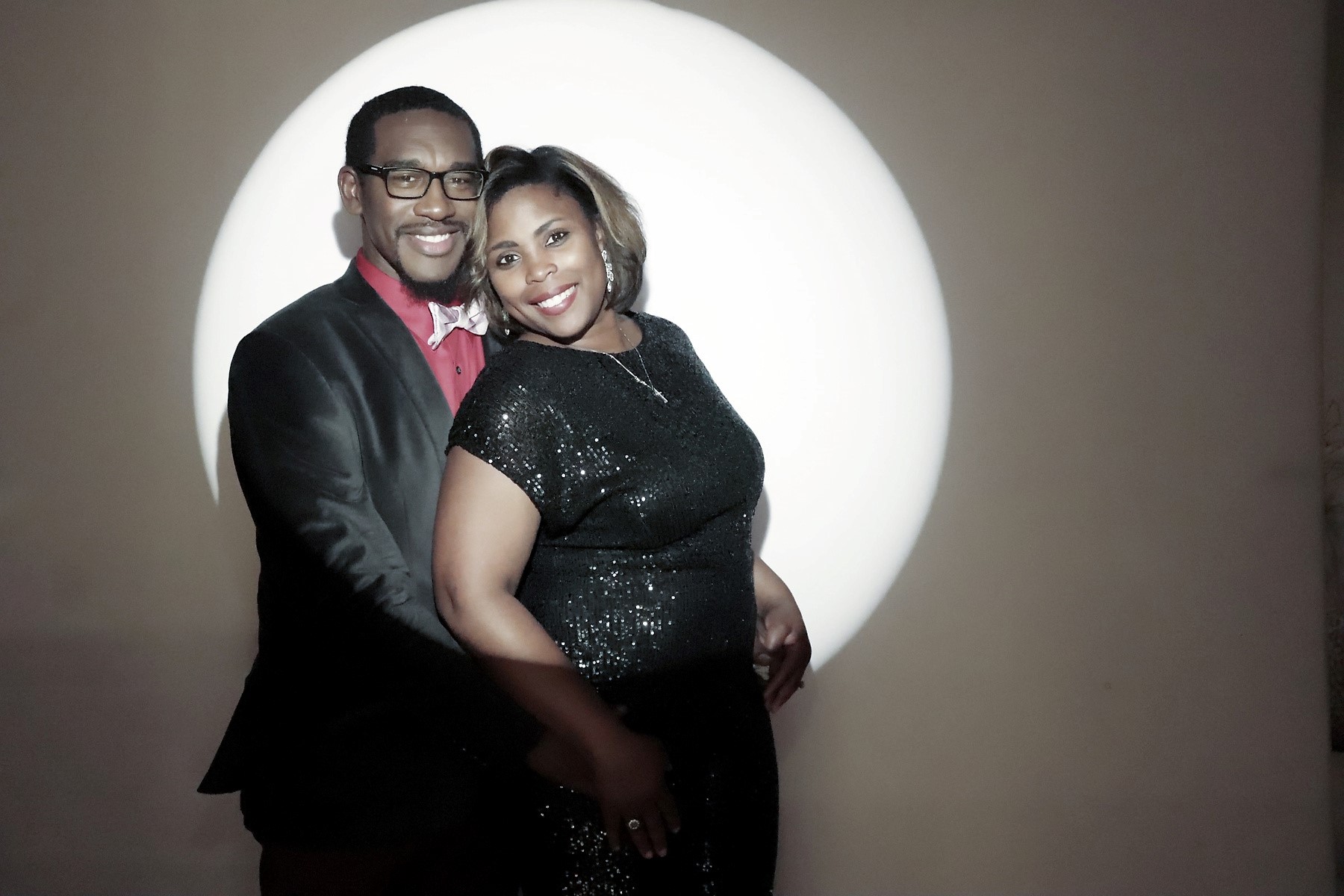 Couple posing under a spotlight at a Flashbar photo booth