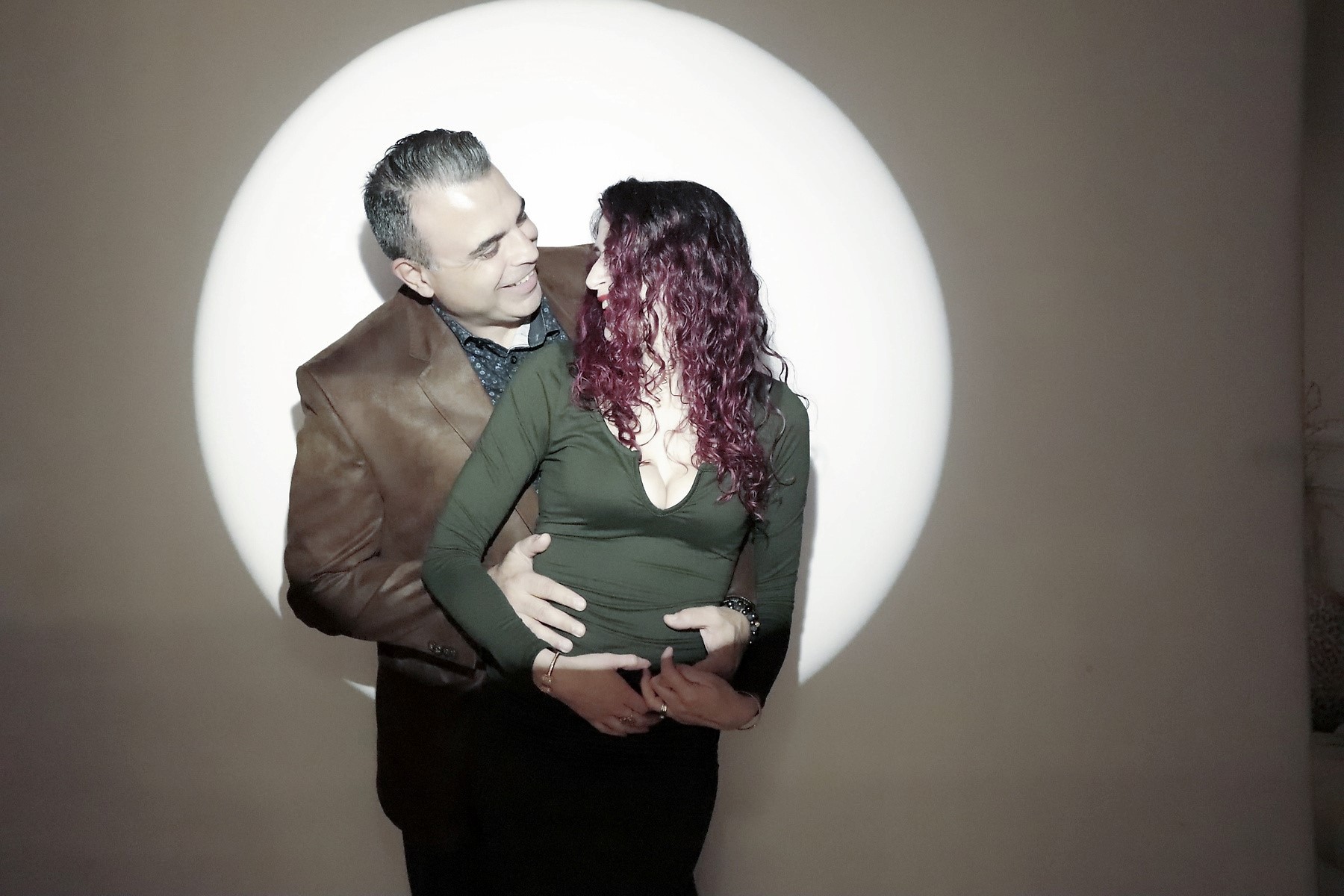 Couple embracing under a spotlight at a Flashbar photo booth