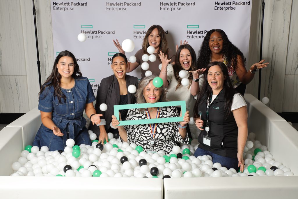 Group of women posing in a Flashbar ball pit photo booth at a Hewlett Packard Enterprise event