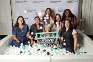Group of women posing in a Flashbar ball pit photo booth at a Hewlett Packard Enterprise event