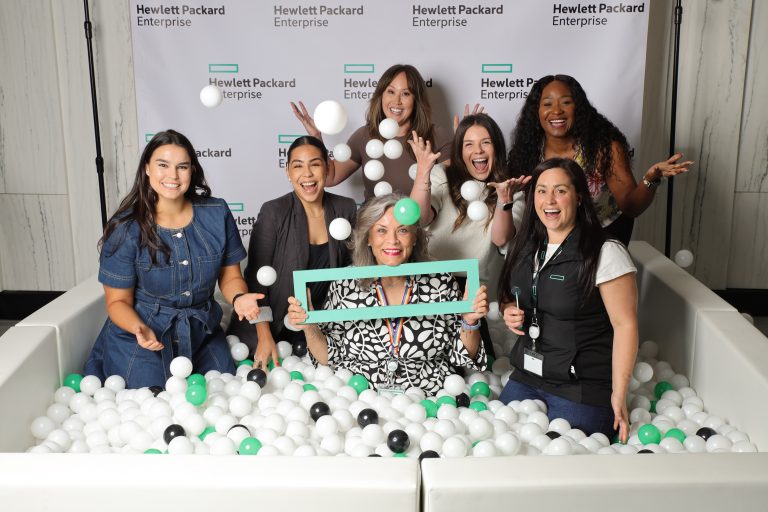 Group of women posing in a Flashbar ball pit photo booth at a Hewlett Packard Enterprise event