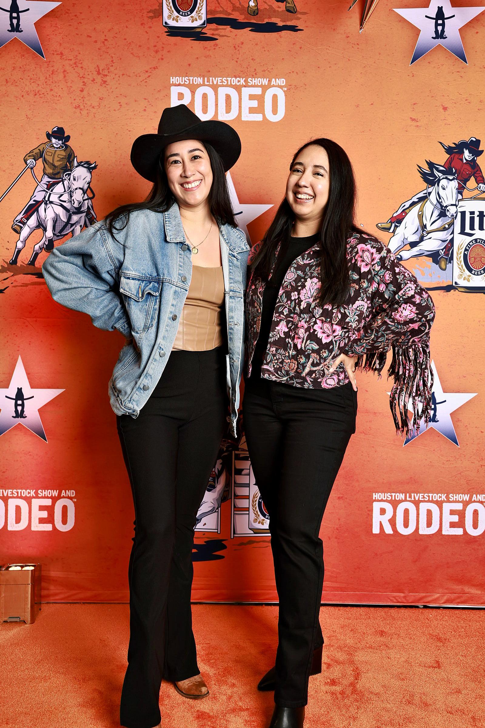 Two women at the Houston Rodeo photo booth backdrop