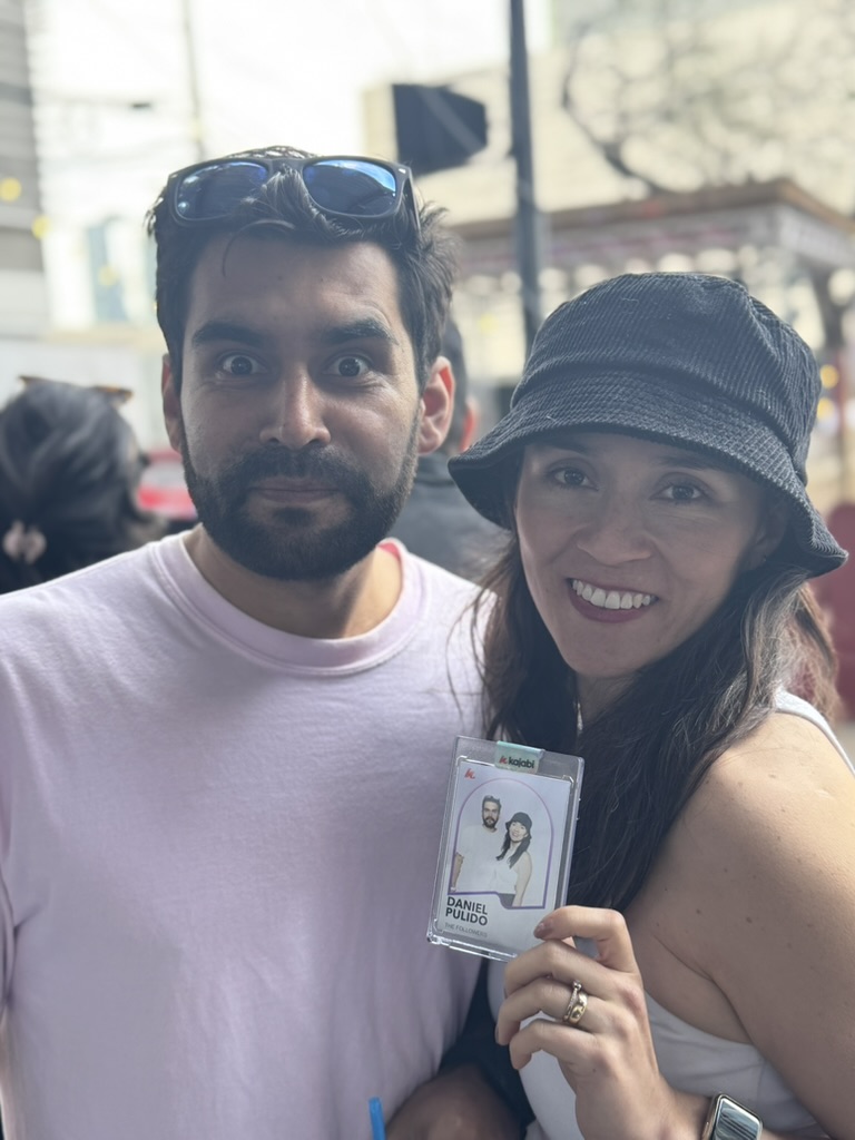 Couple smiling together at an event holding a Flashbar photo booth print